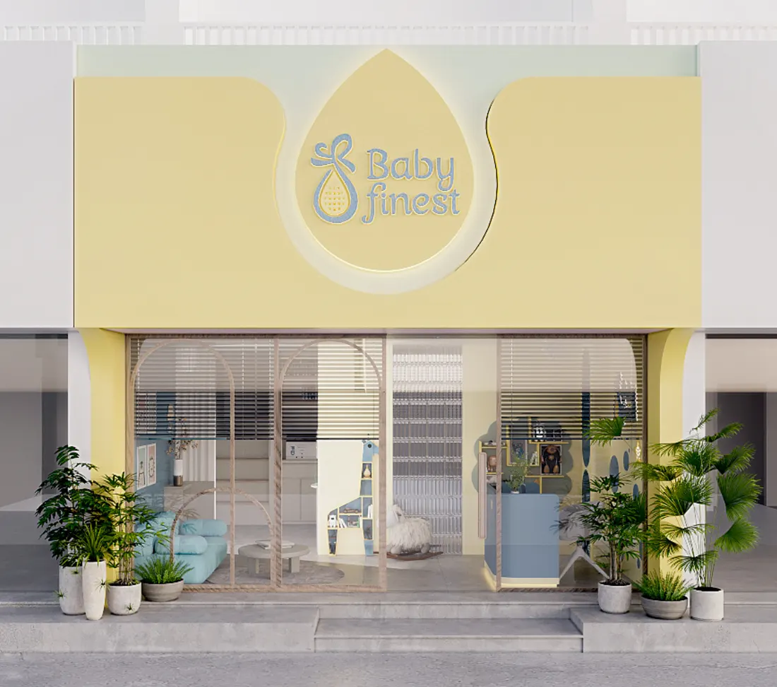 Mặt tiền cơ sở Baby Finest màu vàng sữa với logo giọt sữa